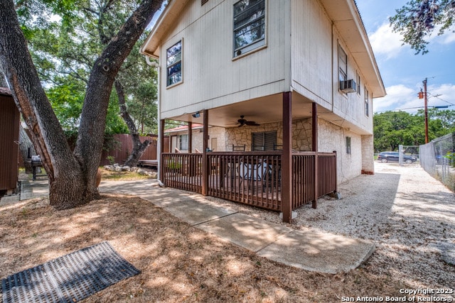 rear view of house featuring ceiling fan