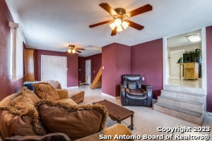 tiled living room featuring ceiling fan