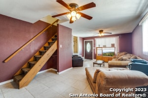 living room featuring ceiling fan and light tile floors