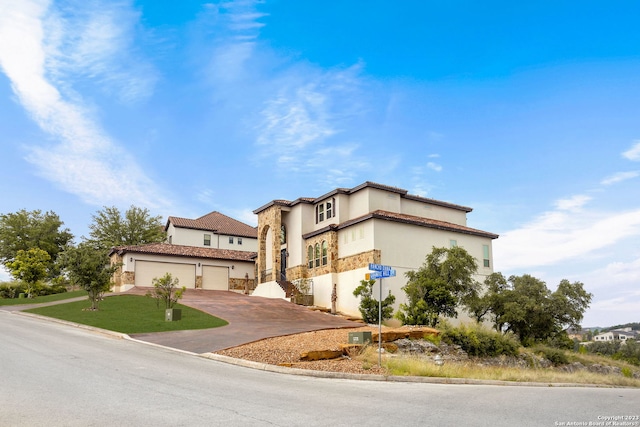 mediterranean / spanish-style house with a garage