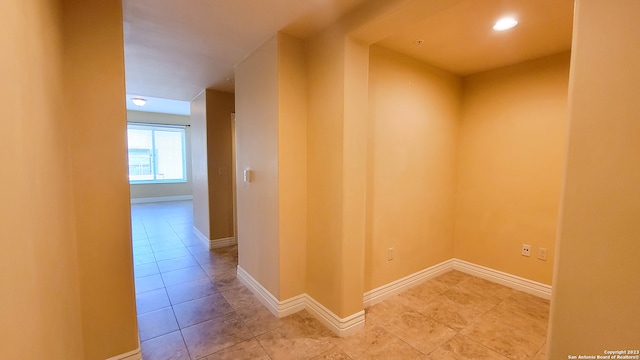 corridor with light tile patterned flooring