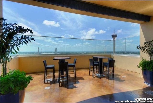 view of patio with a water view and a beach view