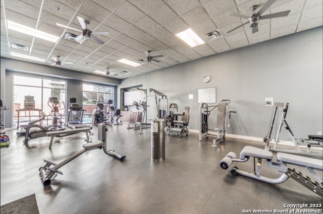 workout area featuring a drop ceiling and ceiling fan