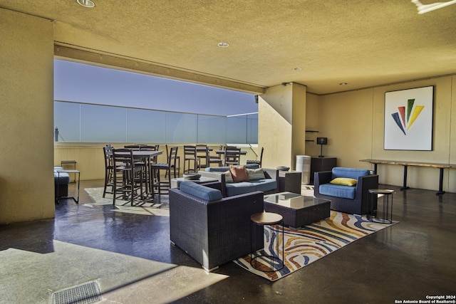 living room featuring concrete flooring and a textured ceiling