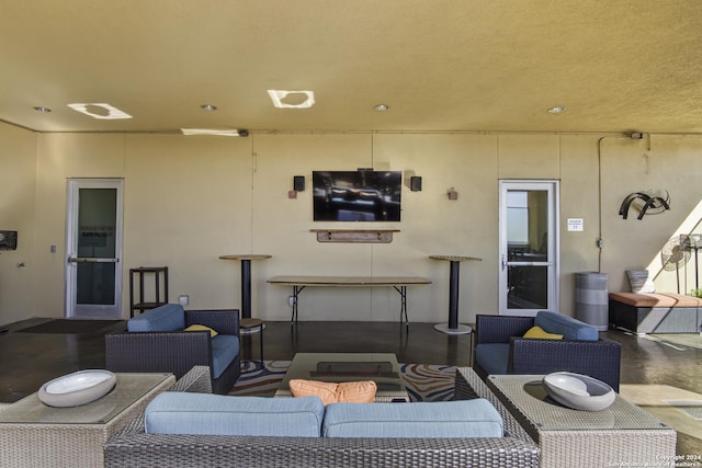 living room featuring concrete flooring and a textured ceiling