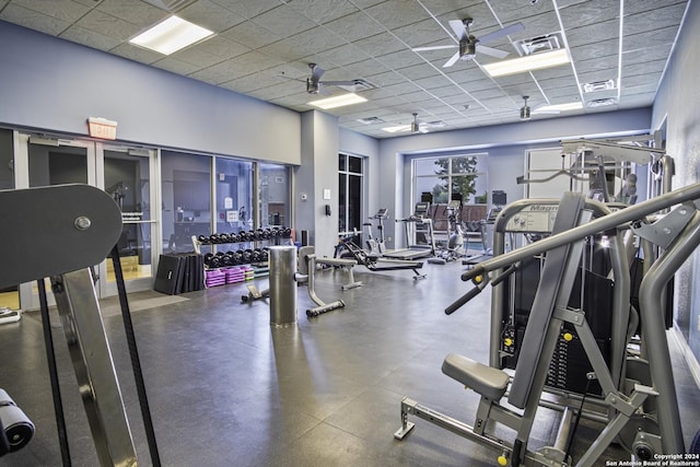 workout area featuring a drop ceiling and ceiling fan