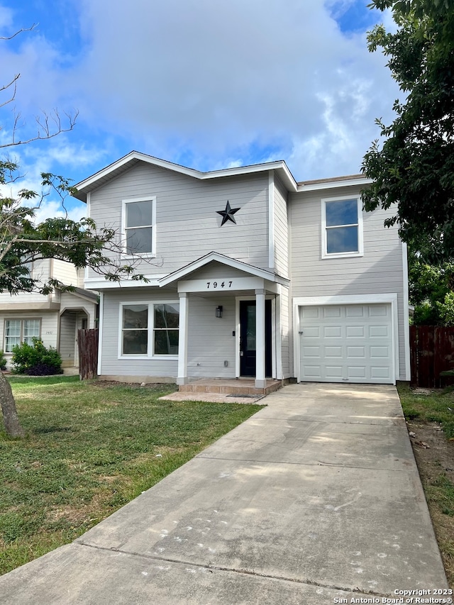 view of front of property featuring a front yard and a garage