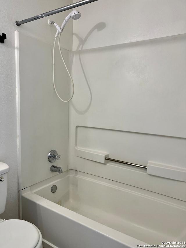 bathroom featuring bathtub / shower combination and toilet