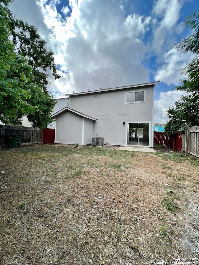 rear view of property with central AC unit