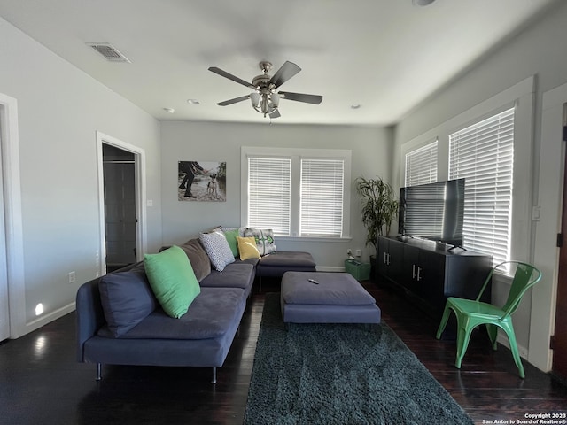 living room with dark wood-type flooring and ceiling fan