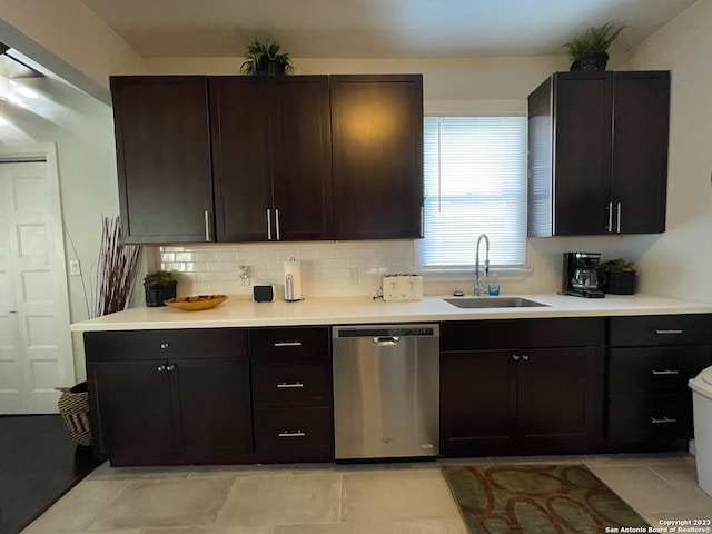 kitchen featuring backsplash, dark brown cabinets, light tile floors, dishwasher, and sink