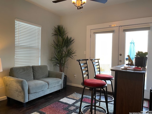 living room with dark wood-type flooring, ceiling fan, and french doors