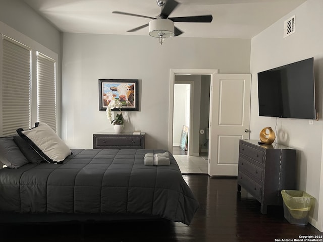 bedroom with dark hardwood / wood-style floors and ceiling fan