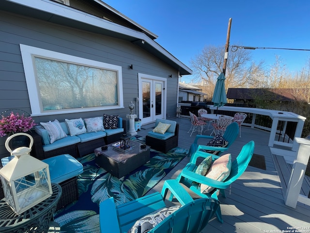 wooden terrace with french doors and outdoor lounge area