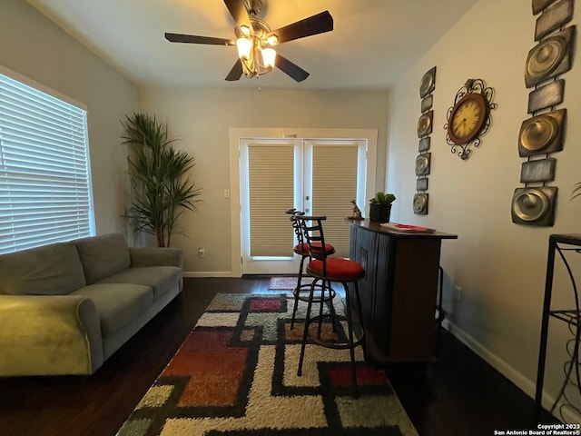 living room with french doors, ceiling fan, and dark hardwood / wood-style flooring