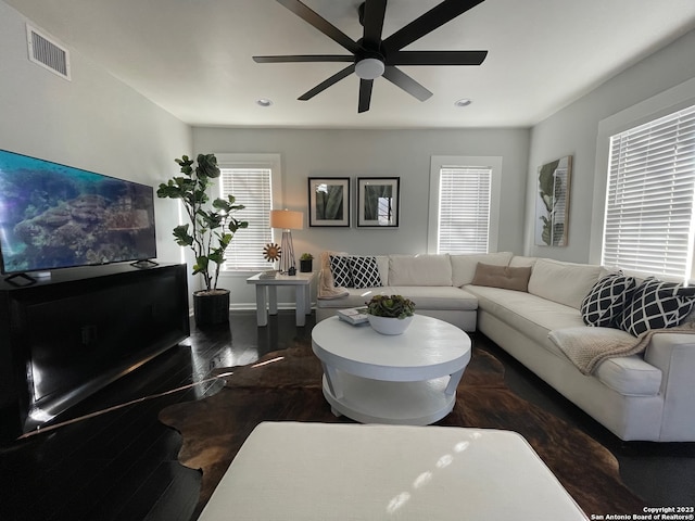 living room with ceiling fan and dark hardwood / wood-style floors