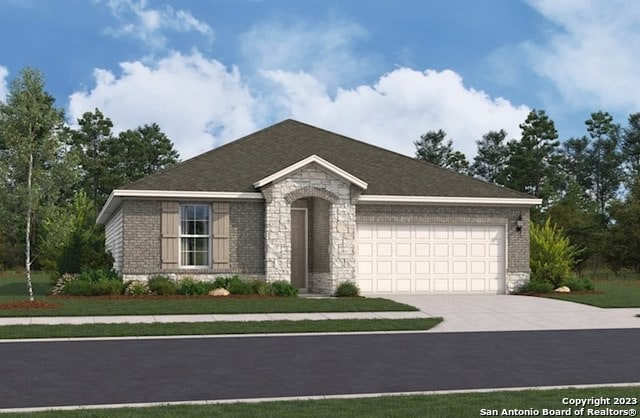 view of front of property with a front yard and a garage