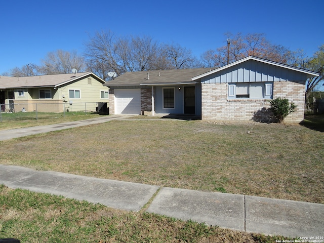 single story home featuring a front lawn and a garage