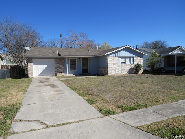 ranch-style house featuring a front lawn and a garage