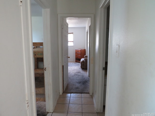 hallway featuring light colored carpet