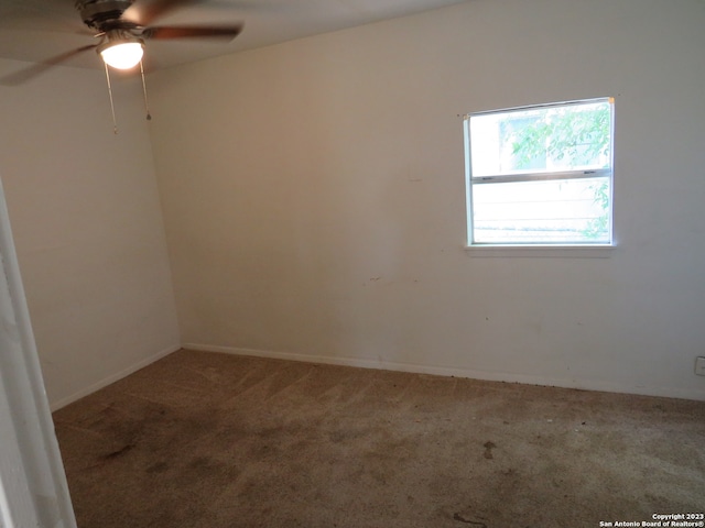 empty room featuring carpet flooring and ceiling fan