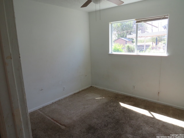 carpeted empty room featuring ceiling fan