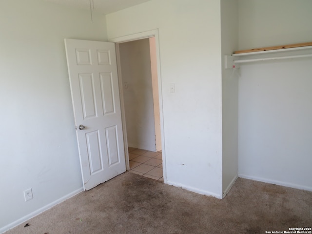 unfurnished bedroom featuring light colored carpet