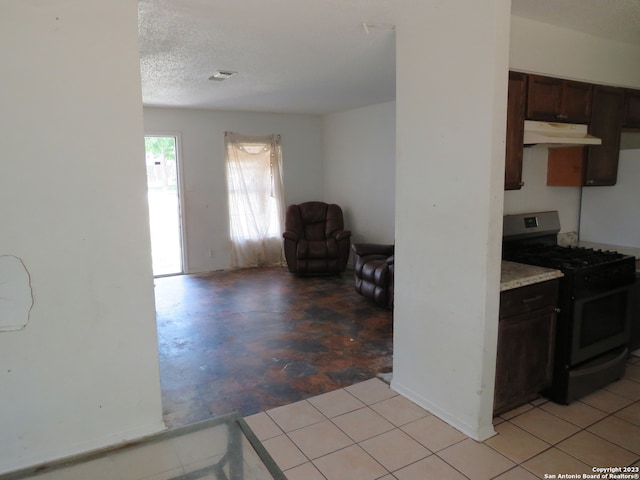 kitchen with range with gas cooktop, dark brown cabinets, and light tile floors