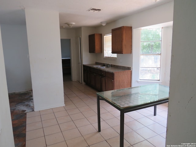 kitchen featuring sink and light tile flooring