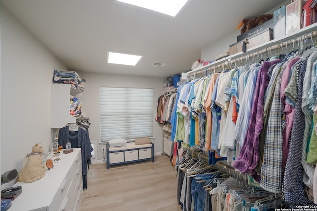 walk in closet with light wood-type flooring