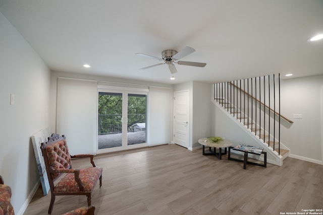 living area featuring ceiling fan and light hardwood / wood-style flooring