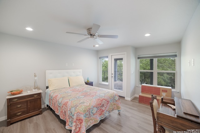 bedroom featuring access to exterior, ceiling fan, and light wood-type flooring