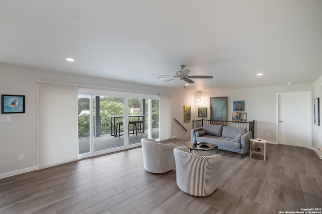 living room featuring hardwood / wood-style floors and ceiling fan