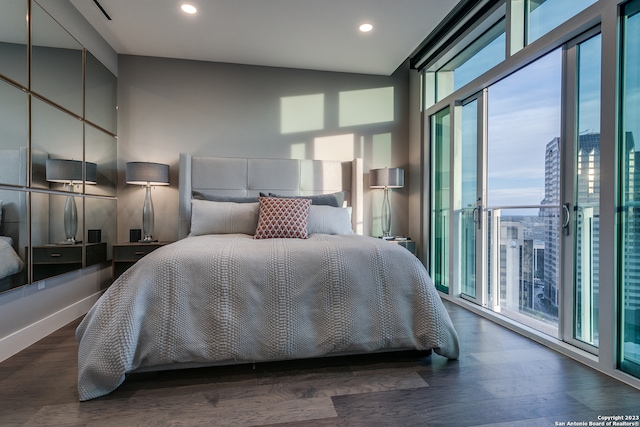 bedroom with dark hardwood / wood-style flooring