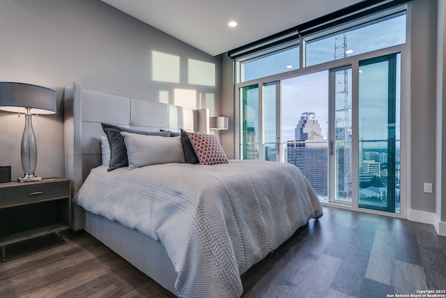 bedroom featuring lofted ceiling, access to outside, and dark wood-type flooring