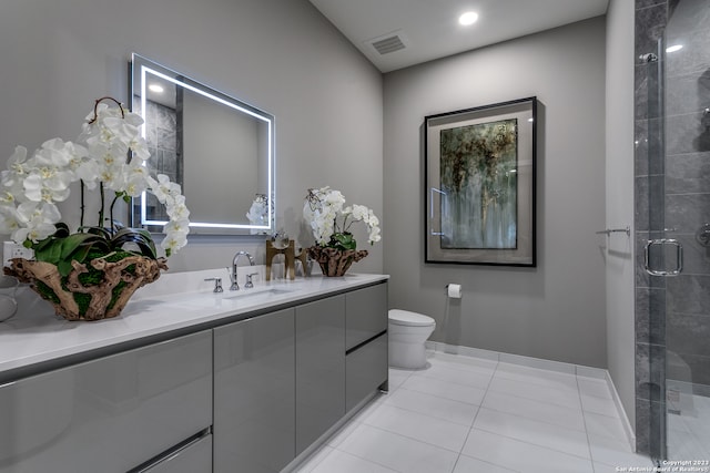 bathroom featuring toilet, tile flooring, walk in shower, and vanity