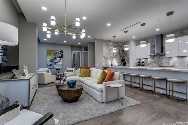 living room with a notable chandelier and wood-type flooring