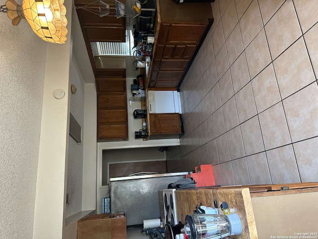 kitchen featuring tile walls