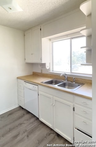 kitchen featuring sink, dark wood-type flooring, dishwasher, and white cabinetry