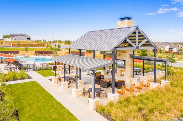 view of home's community featuring a gazebo, a swimming pool, a yard, and a patio