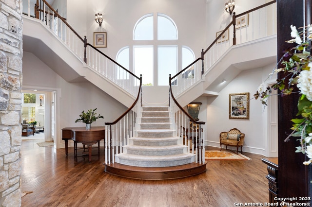 interior space featuring a high ceiling and hardwood / wood-style flooring