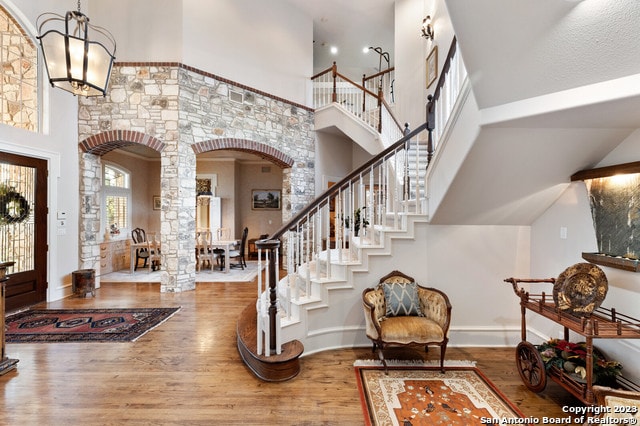 entrance foyer featuring a high ceiling and wood-type flooring