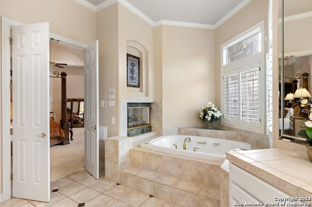 bathroom with ceiling fan, crown molding, a multi sided fireplace, a relaxing tiled bath, and tile flooring