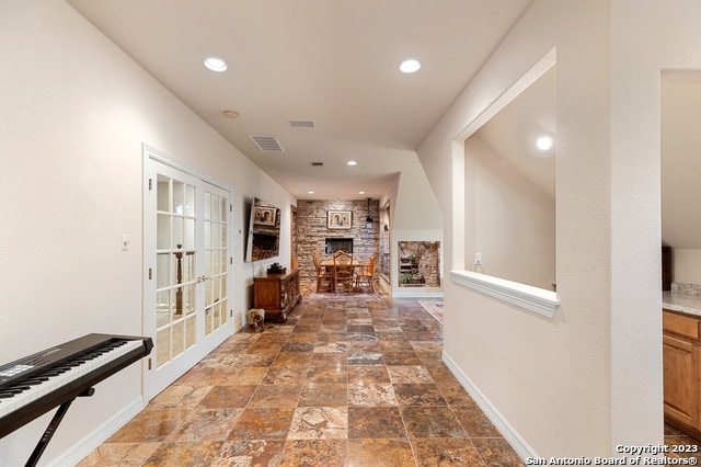 hallway featuring dark tile floors