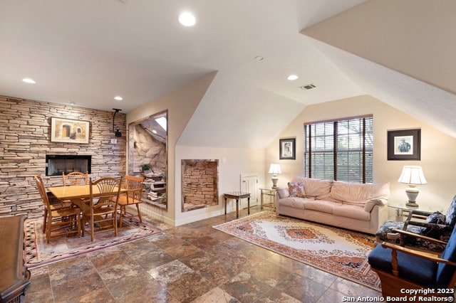 living room featuring dark tile flooring and a fireplace