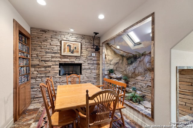 dining area with a stone fireplace