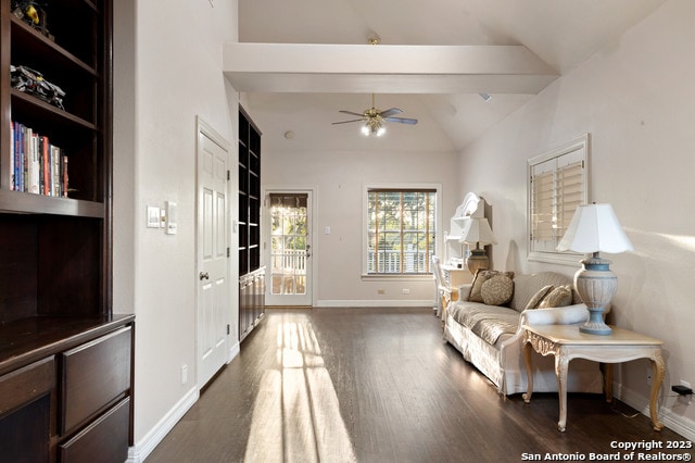 living room with lofted ceiling, dark hardwood / wood-style floors, and ceiling fan