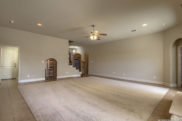 tiled empty room with ceiling fan