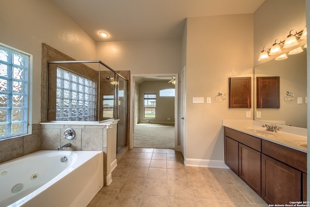 bathroom featuring separate shower and tub, tile floors, and vanity with extensive cabinet space