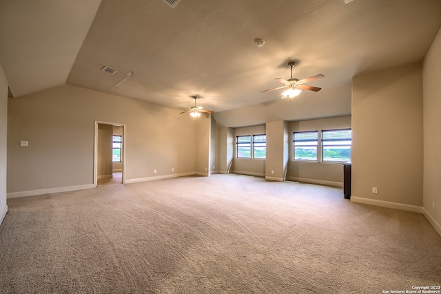 carpeted spare room with vaulted ceiling and ceiling fan